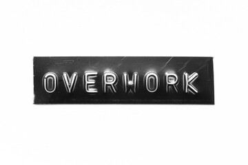 Black color banner that have embossed letter with word overwork on white paper background