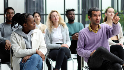 Close-up of people chatting, sitting in a circle and gesturing