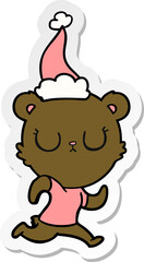 peaceful sticker cartoon of a bear running wearing santa hat