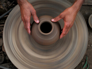 close up of hands of a potter, A Potter Making A Pot On a Manual Wheel