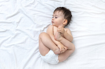 baby isolated on bed blanket with legs up head on side mockup free space for text high quality...
