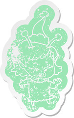 cute alien girl cartoon distressed sticker of a wearing santa hat