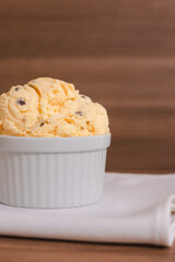 Close-up of an American-flavored ice cream with raisins on a wooden table.