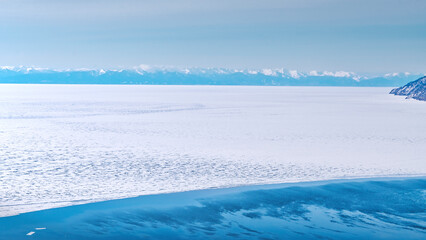 Ice of Lake Baikal, Source of the Angara river, view from above. 