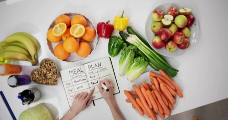 Female Dietitian Doctor Writing Meal Plan