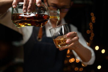 Barman pouring whiskey whiskey glass beautiful night