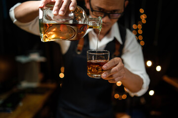 Barman pouring whiskey whiskey glass beautiful night