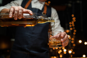 Barman pouring whiskey whiskey glass beautiful night