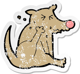 retro distressed sticker of a cartoon dog scratching