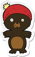 sticker of a cartoon cute black bear in hat
