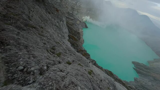 FPV drone flies over volcano Ijen and acid lake in Indonesian island Jawa