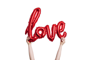 Red foil Love balloon held against a plain white background