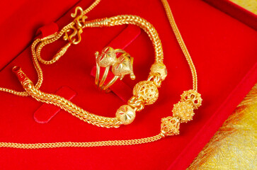 The Gold Bracelet in red velvet box container.
