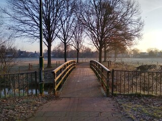 Small cycling bridge over the canal on a winter morning
