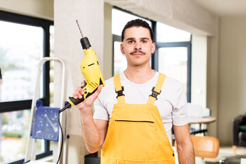 young handsome man handyman or housekeeper concept at home interior