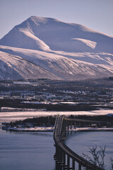 View from the island of Kvaloya, a very beautiful landscape opens up with a bridge and mountains
