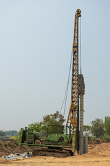 Green mobile crane working on construction site