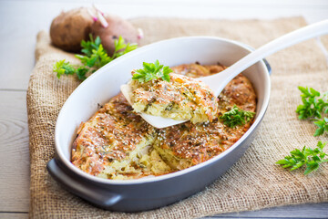 potato casserole with cabbage and spices in a ceramic form