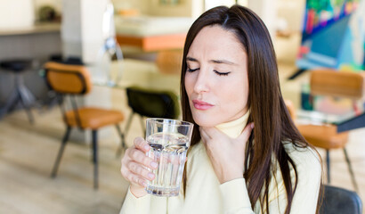 young adult woman with a water glass