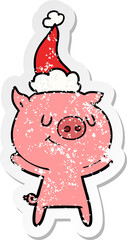 happy distressed sticker cartoon of a pig wearing santa hat