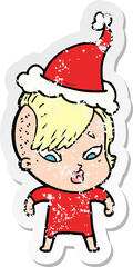 distressed sticker cartoon of a surprised girl wearing santa hat