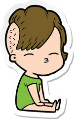 sticker of a cartoon squinting girl