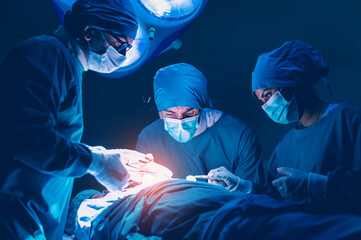 Group of concentrated surgical doctor team doing surgery patients in hospital operating theater. Professional medical team doing critical operations. - obrazy, fototapety, plakaty