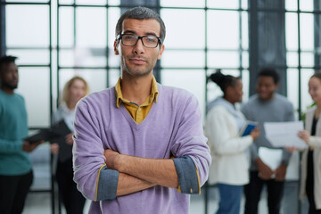 Fototapeta premium Young handsome man in elegant clothes and glasses looks away