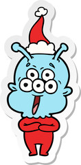 happy sticker cartoon of a alien wearing santa hat
