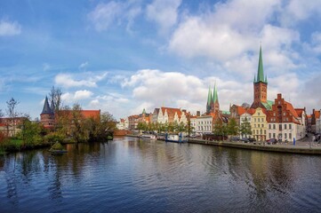 View of the historic city during the bottom with blue sky, clouds and lake. The old Hanseatic city...