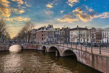 Fototapeta premium Amsterdam Netherlands, sunset city skyline at canal waterfront