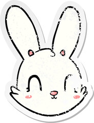 distressed sticker of a cartoon bunny face