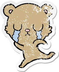 distressed sticker of a crying cartoon bear running away