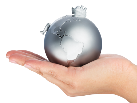 Hand holds metal earth with ship