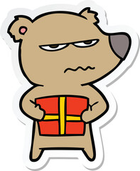 sticker of a angry bear cartoon holding present