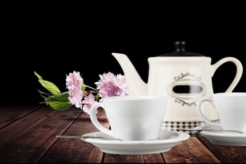 Tea concept, teapot and cups on the desk