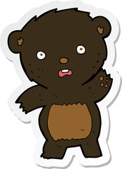 sticker of a cartoon waving black bear cub
