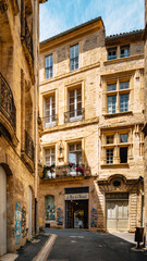 Quaint street of Rue Alfred Sabatier with medieval stone facades in the old town of Pezenas in the south of France (Herault).