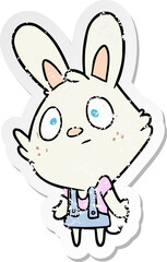 distressed sticker of a cartoon rabbit shrugging shoulders