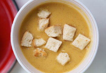 Cream soup bowl in flat lay. Overhead photo of hot champignon mushroom soup cooked with crusty croutons and cheese