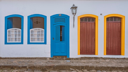 Paraty, Brazil. House with colorful doors and windows from the colonial period and a cobblestone street in the historic center.