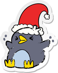 distressed sticker of a cartoon penguin wearing christmas hat