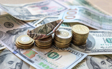 Dollar bills laid out on table. A dollar boat on the middle column of coins, four columns of coins, financial crisis, money, finance, savings, salary, bank, euro cents. Photo, macro photography