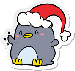 sticker of a cartoon penguin wearing christmas hat
