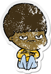distressed sticker of a cartoon angry boy sitting