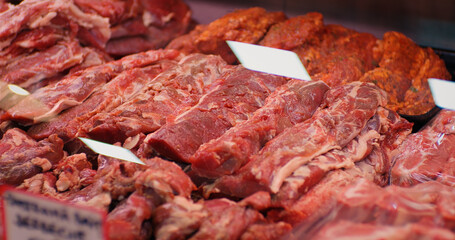 Display of assorted chopped raw lamb meat in butchers shop for sale. Fresh organic meat department in supermarket.