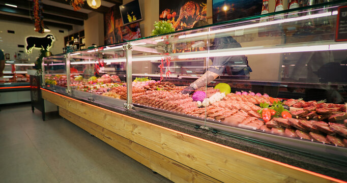 Chops of beef meat on skewers layout in the store. Selection of different cuts of fresh meat raw red in a supermarket.