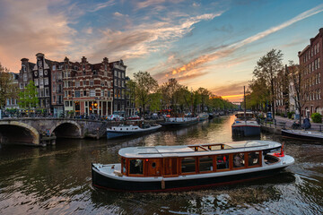 Amsterdam Netherlands, sunset city skyline at canal waterfront - 580711048