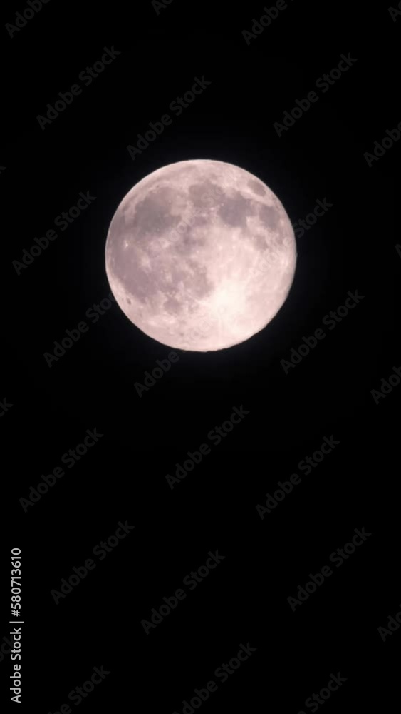 Wall mural magical full moon at night. telephoto view of mysterious clouds flying against the bright full moon.