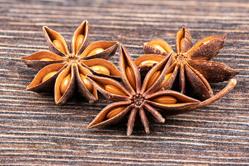 Star anise close-up on a wooden background.